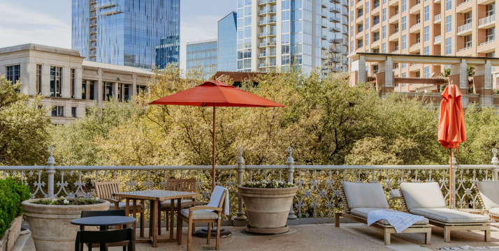 A balcony with outdoor furniture and a city view